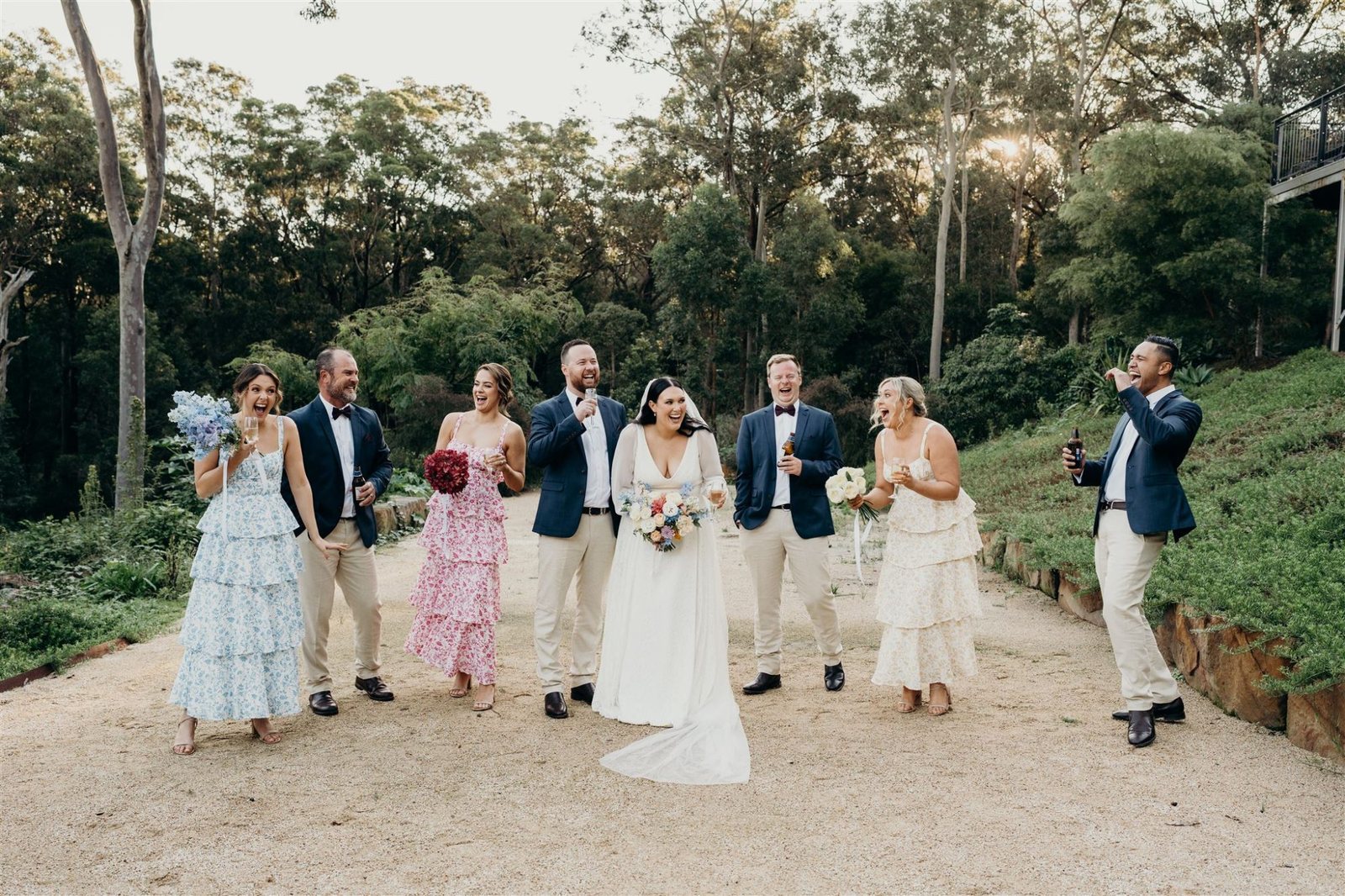 A bridal party walking the gravel path