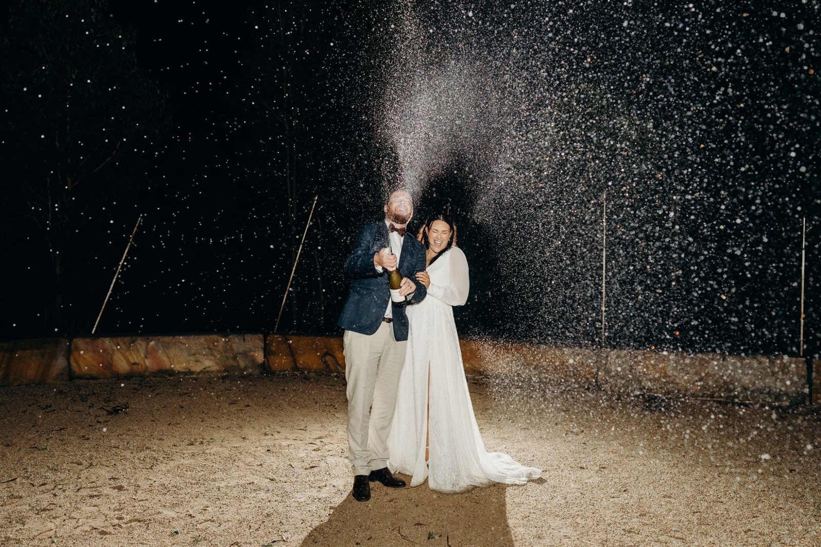 A couple embracing at night under a shower of light