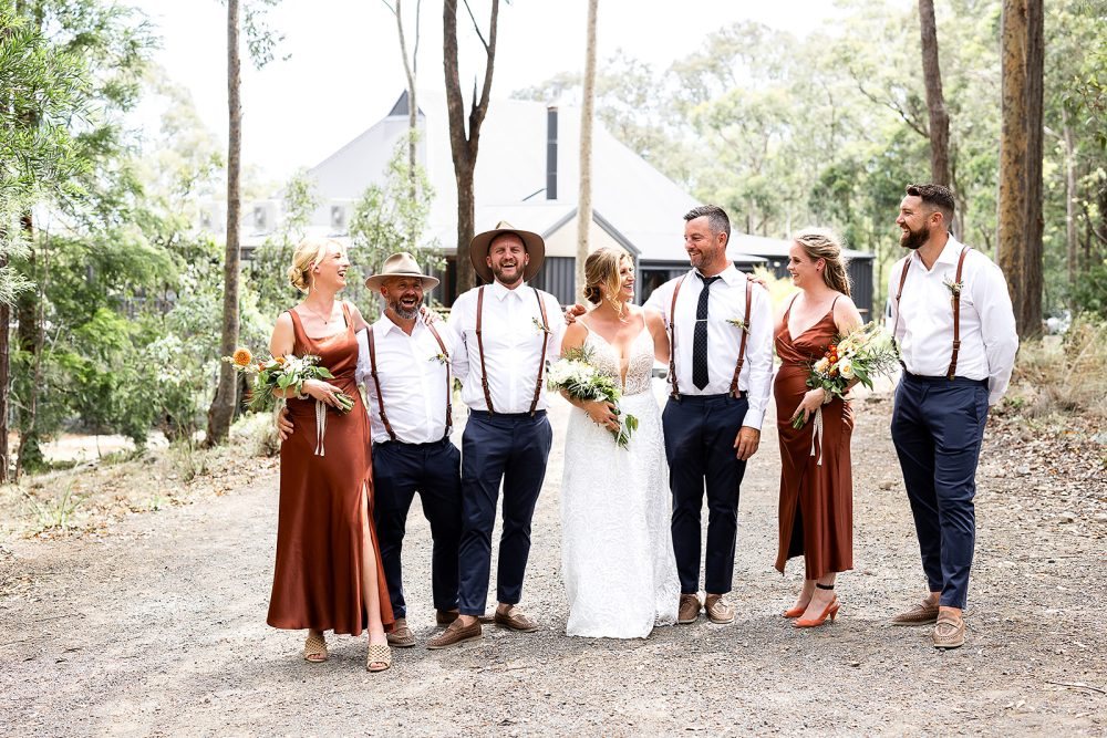 A bridal party lined up on the bush track